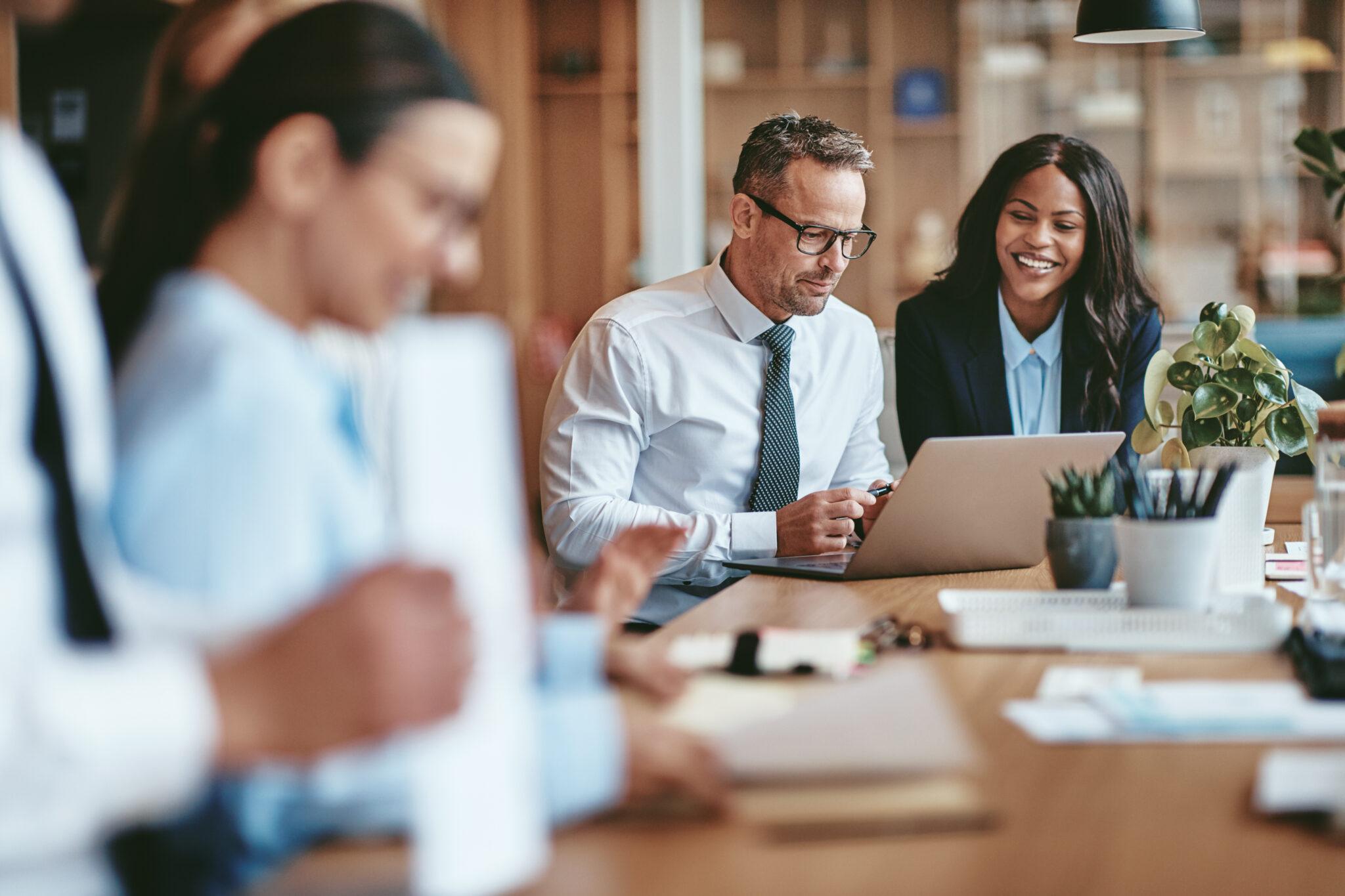 Financial professionals reviewing work together around a table